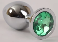 Серебристая анальная пробка с зелёным стразом - 9,5 см.